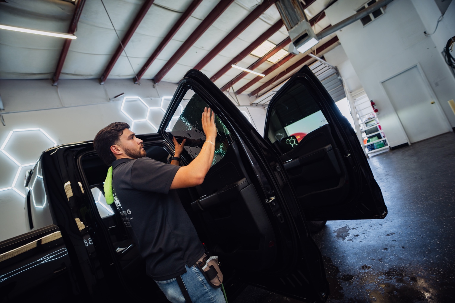 Tint Plug installer working on truck window