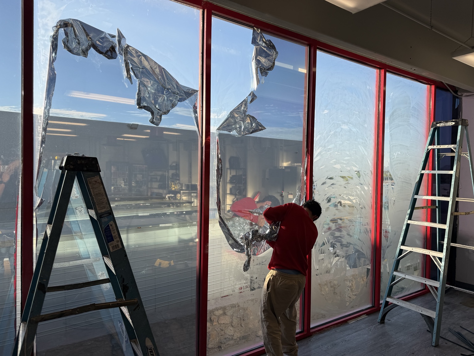 Commercial window tint installation in progress
