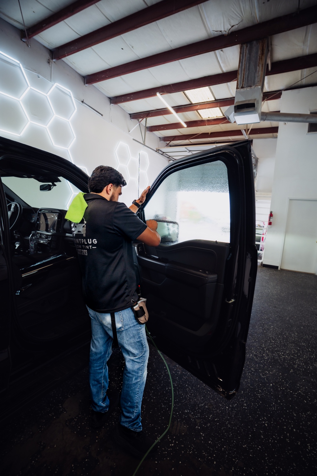 Tint installer working on truck